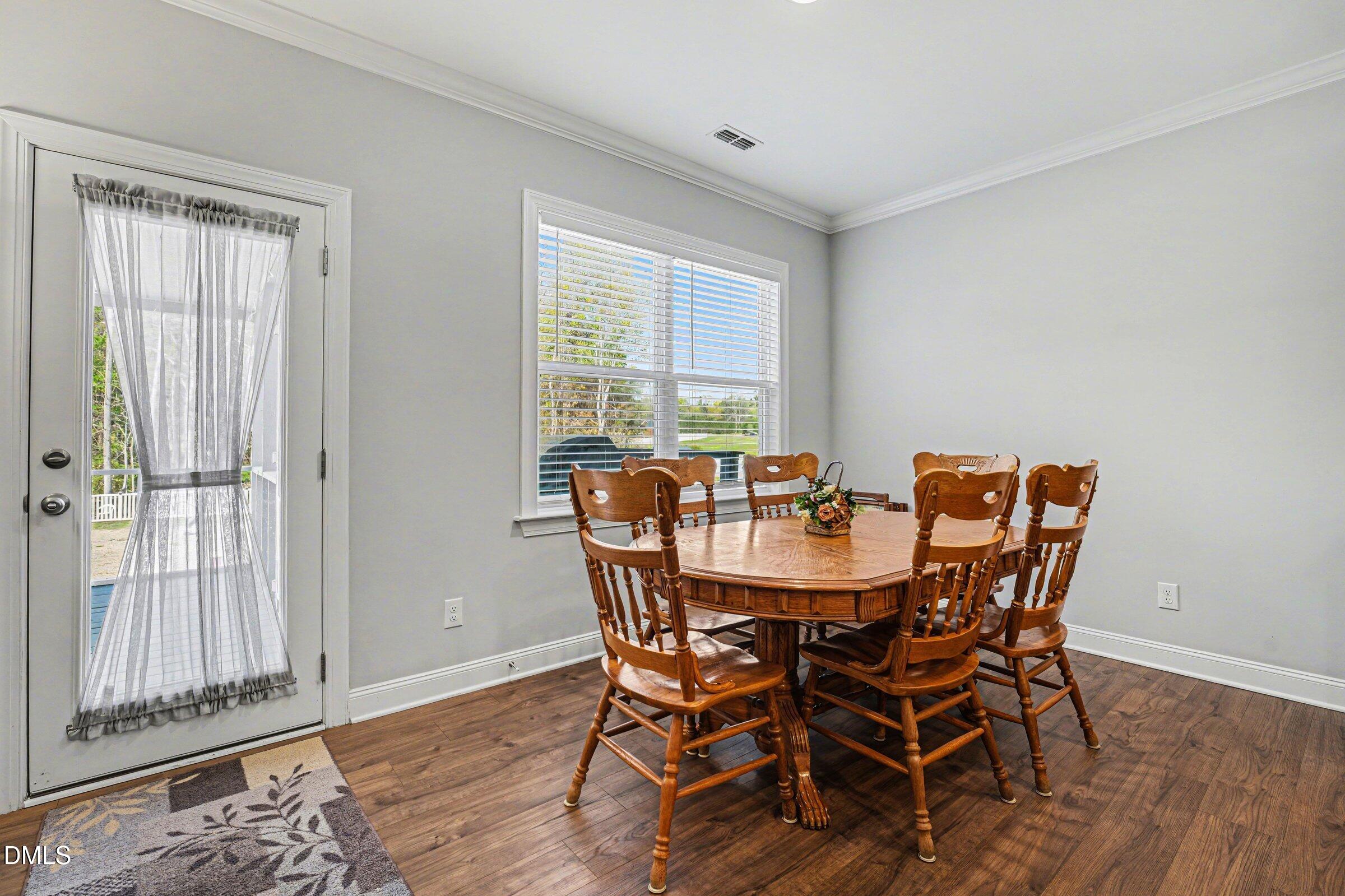 130 Aylebury Ridge Zebulon, NC 27597 - Photo 7 of 41 a view of a dining room with furniture window and wooden floor