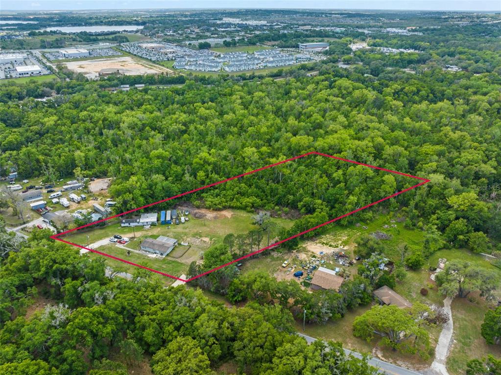 16838 Old Highway 50 East Clermont, FL 34711 - Photo 35 of 51 an aerial view of residential houses with outdoor space and trees
