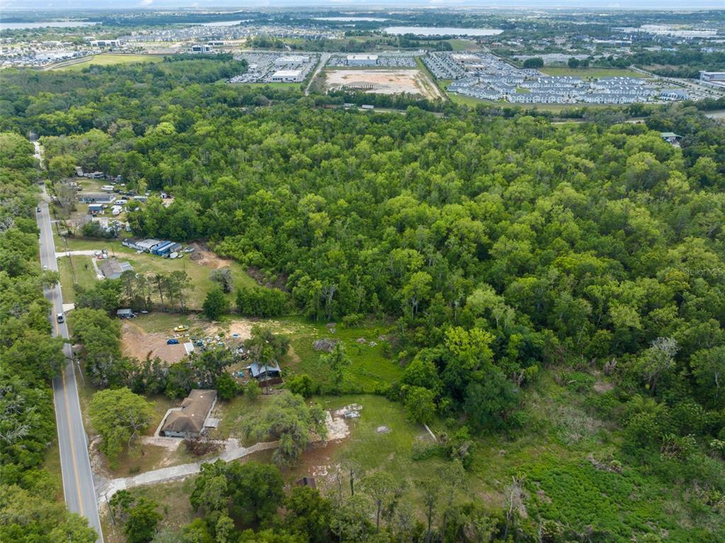 16838 Old Highway 50 East Clermont, FL 34711 - Photo 37 of 51 an aerial view of residential houses with outdoor space and trees