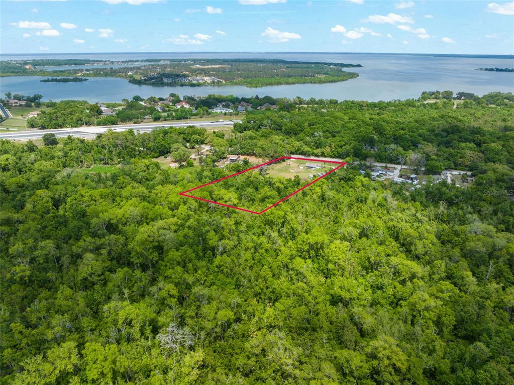 16838 Old Highway 50 East Clermont, FL 34711 - Photo 42 of 51 a view of a lake with a building in the background