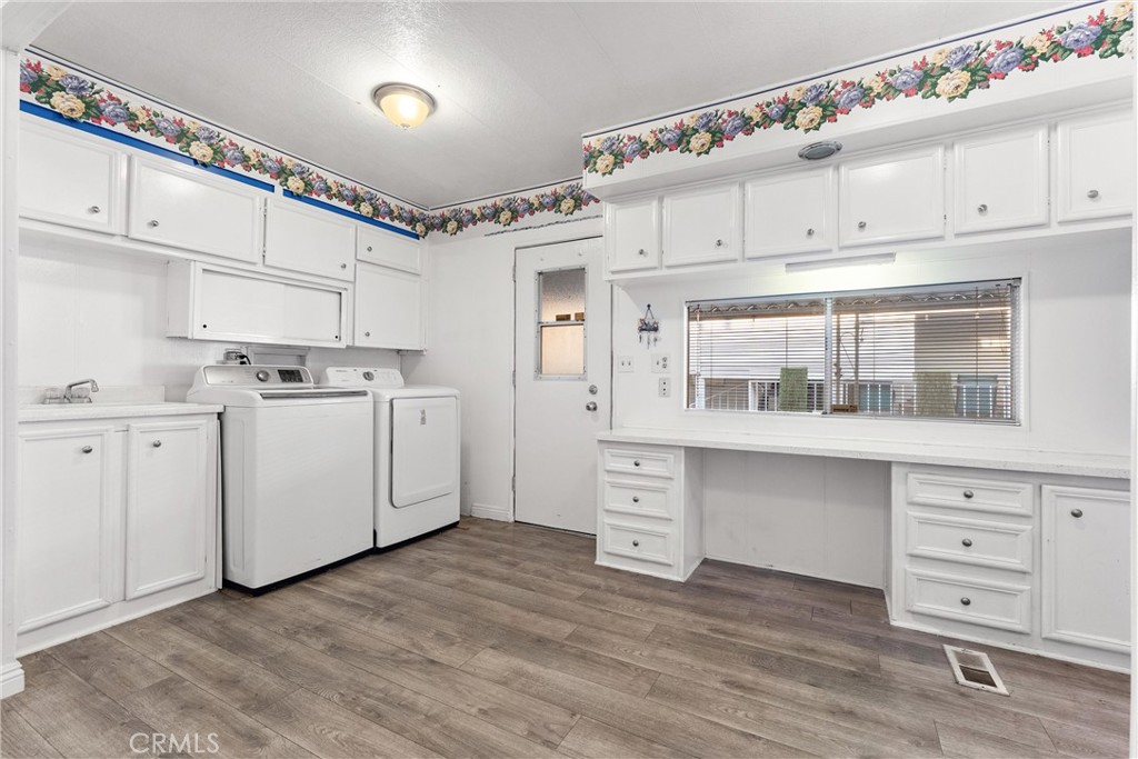 a utility room with cabinets washer and dryer