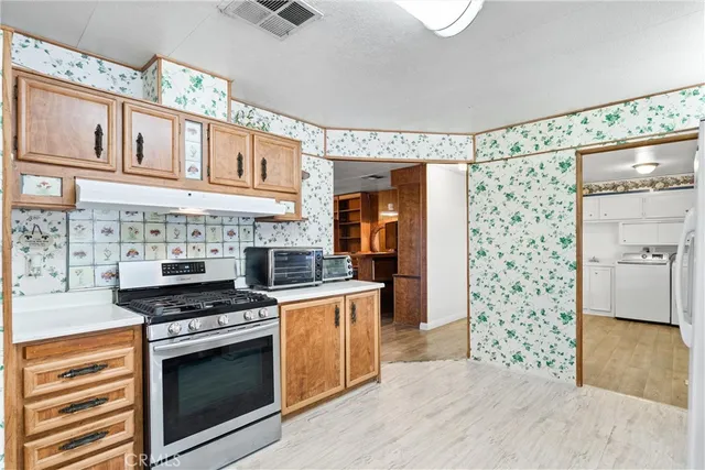a kitchen with stainless steel appliances a stove and a refrigerator