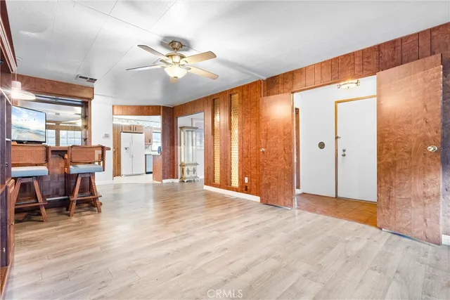 a view of a livingroom with furniture and chandelier fan