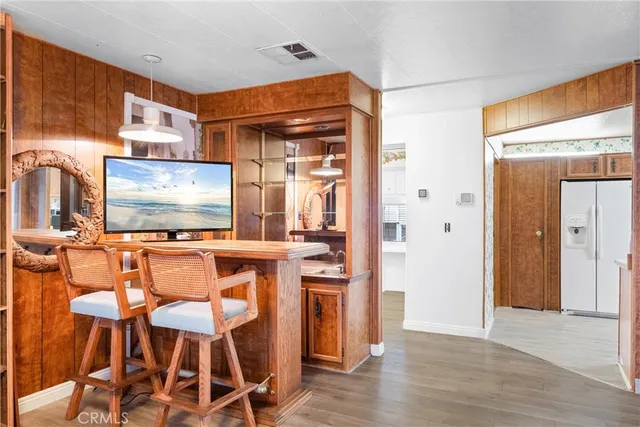 a kitchen with stainless steel appliances kitchen island granite countertop a refrigerator and microwave