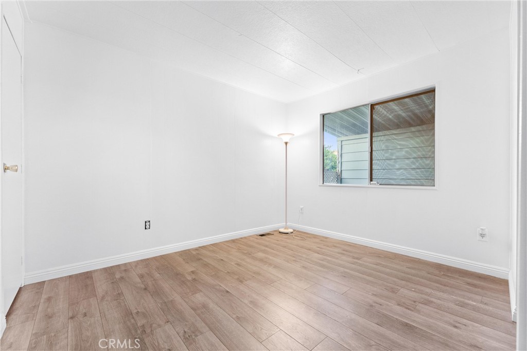 1400 South Sunkist, Unit 80 Anaheim, CA 92806 - Photo 25 of 48 an empty room with wooden floor and windows