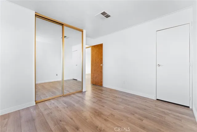 an empty room with wooden floor and a door