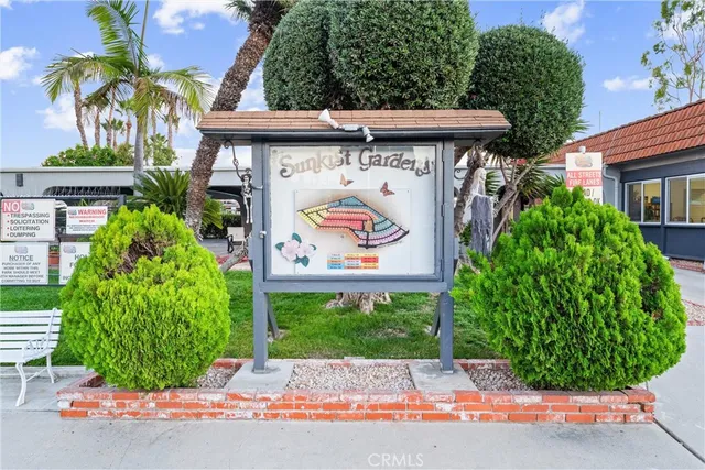 a view of a street with potted plants