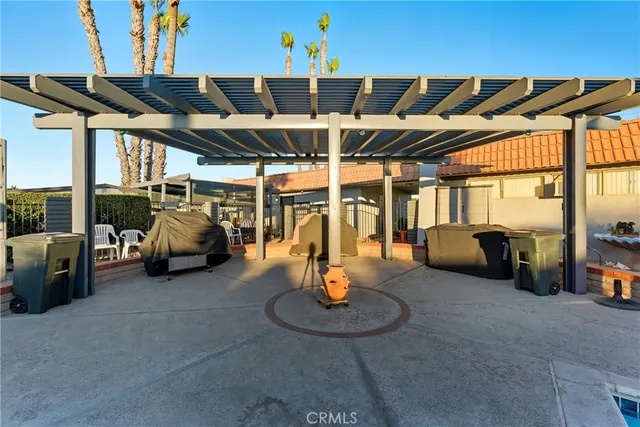 a view of a patio with table and chairs potted plants