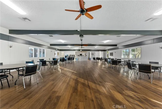 a view of a room with lots of furniture and wooden floor