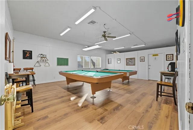 a room with furniture pool table and wooden floor