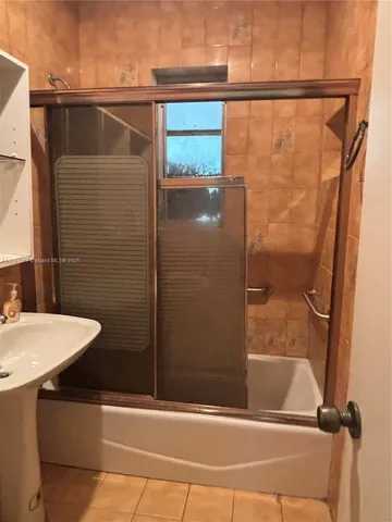 a bathroom with a shower and a sink