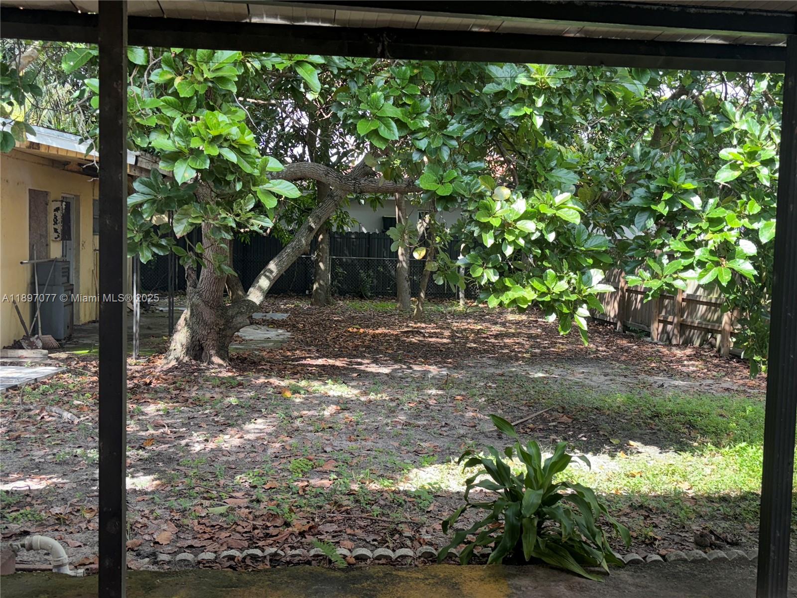 6261 Southwest 6th Street Miami, FL 33144 - Photo 22 of 29 a backyard of a house with lots of green space