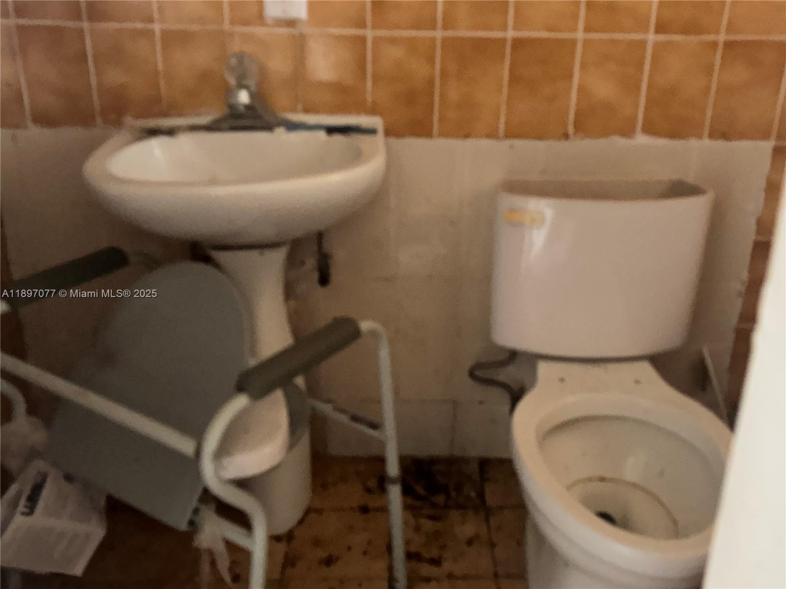 6261 Southwest 6th Street Miami, FL 33144 - Photo 27 of 29 a bathroom with a toilet and a sink