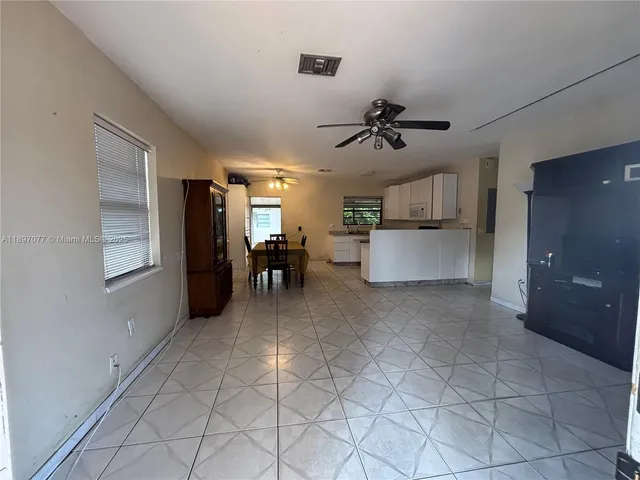 a view of a kitchen with furniture and a ceiling fan