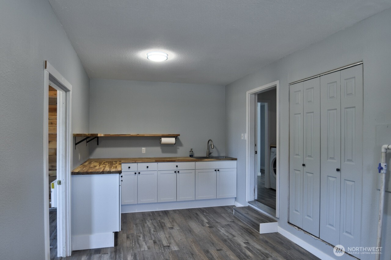 8603 194th Avenue Southwest Rochester, WA 98579 - Photo 13 of 32 a kitchen with stainless steel appliances cabinets and wooden floor