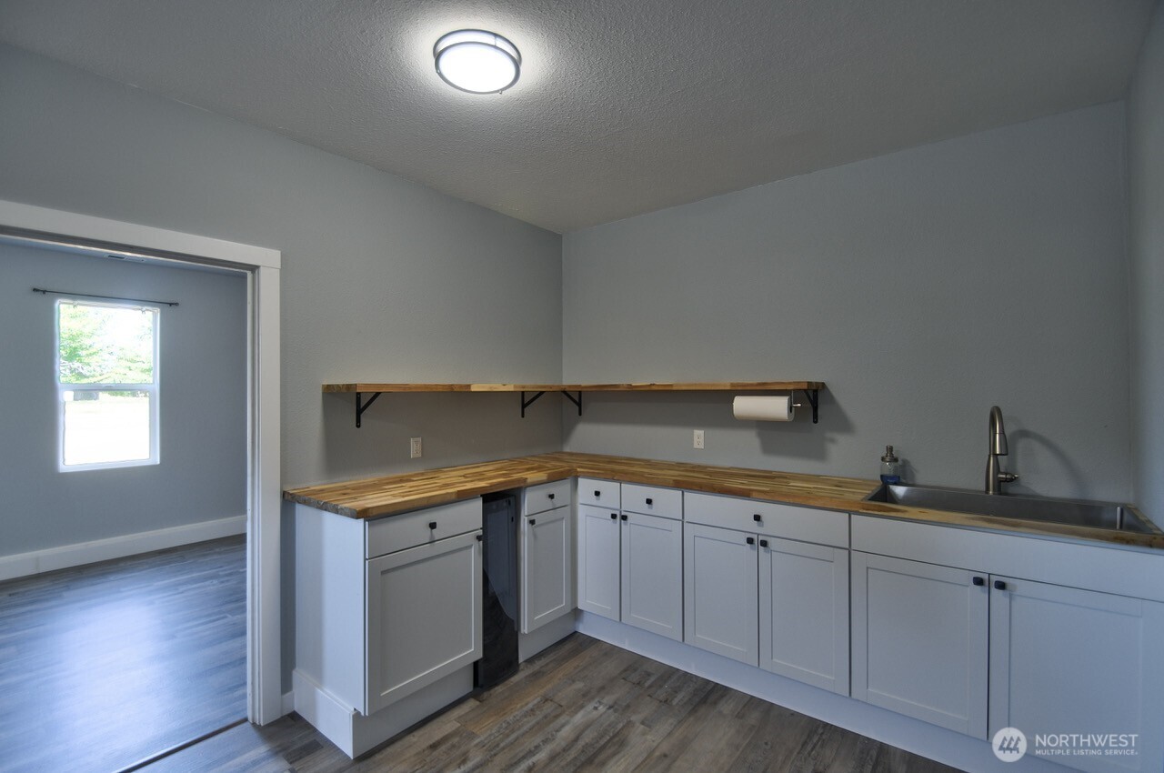8603 194th Avenue Southwest Rochester, WA 98579 - Photo 14 of 32 a kitchen with a sink and cabinets