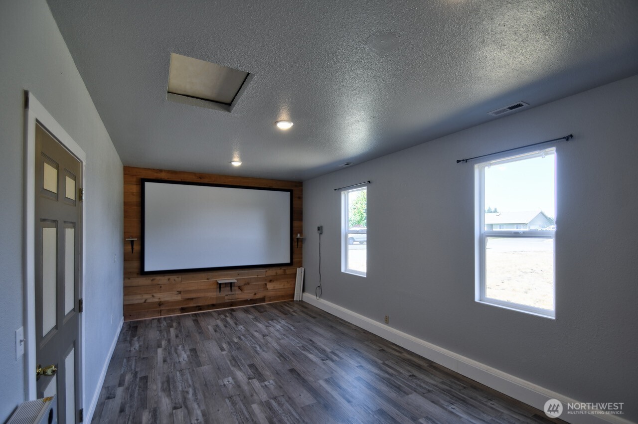 8603 194th Avenue Southwest Rochester, WA 98579 - Photo 16 of 32 a view of wooden floor and windows in a room