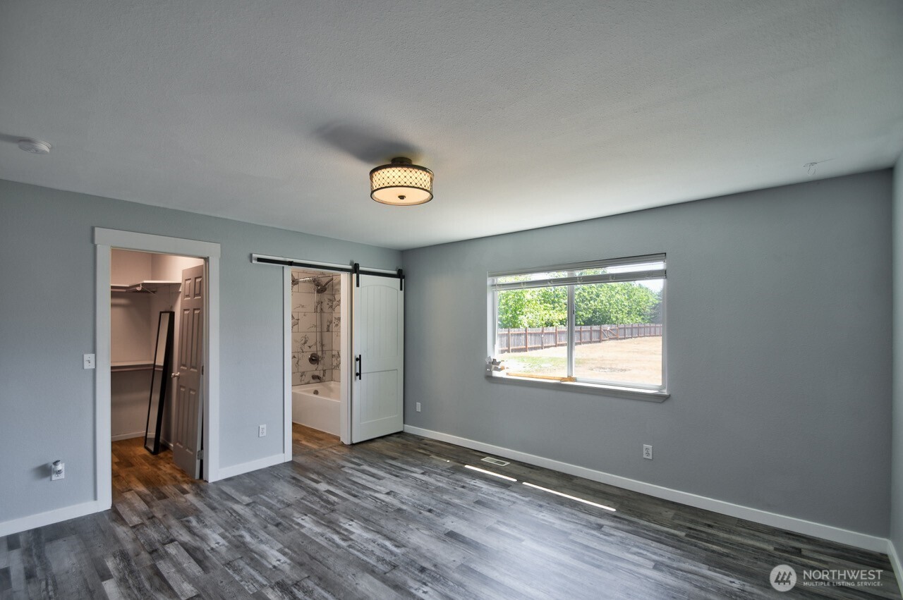 8603 194th Avenue Southwest Rochester, WA 98579 - Photo 20 of 32 an empty room with window and wooden floor