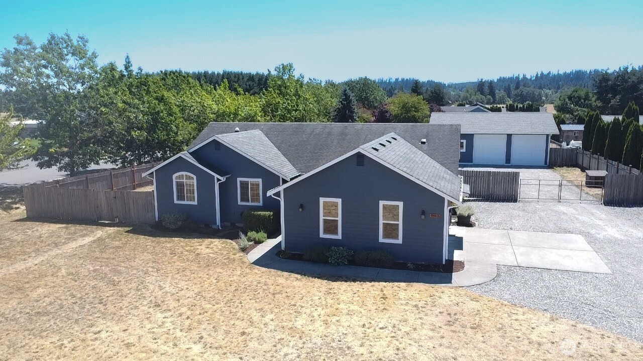 8603 194th Avenue Southwest Rochester, WA 98579 - Photo 29 of 32 a front view of a house with a yard covered in snow