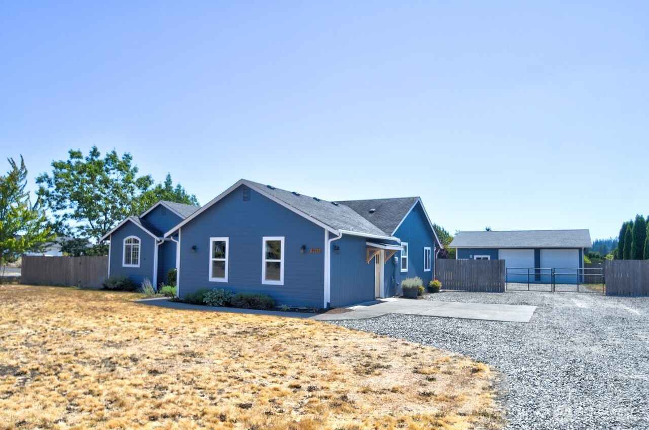8603 194th Avenue Southwest Rochester, WA 98579 - Photo 3 of 32 a front view of a house with a yard and garage