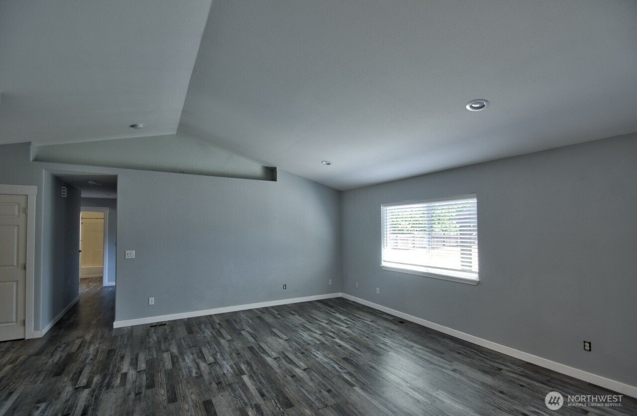 8603 194th Avenue Southwest Rochester, WA 98579 - Photo 6 of 32 an empty room with wooden floor and windows