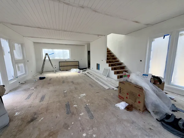a view of a bedroom with wooden floor and stairs