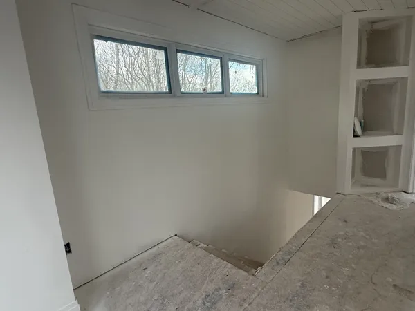a view of wooden floor and windows in a room