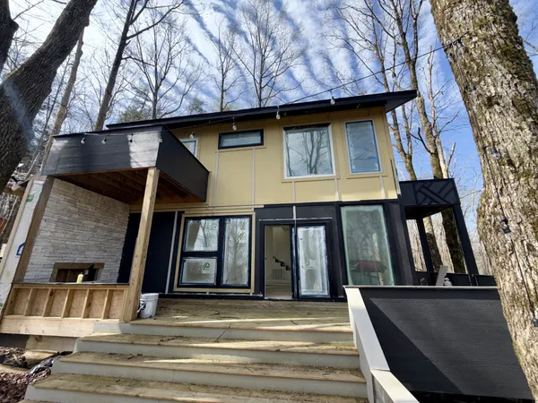 a view of outdoor space with front door and deck
