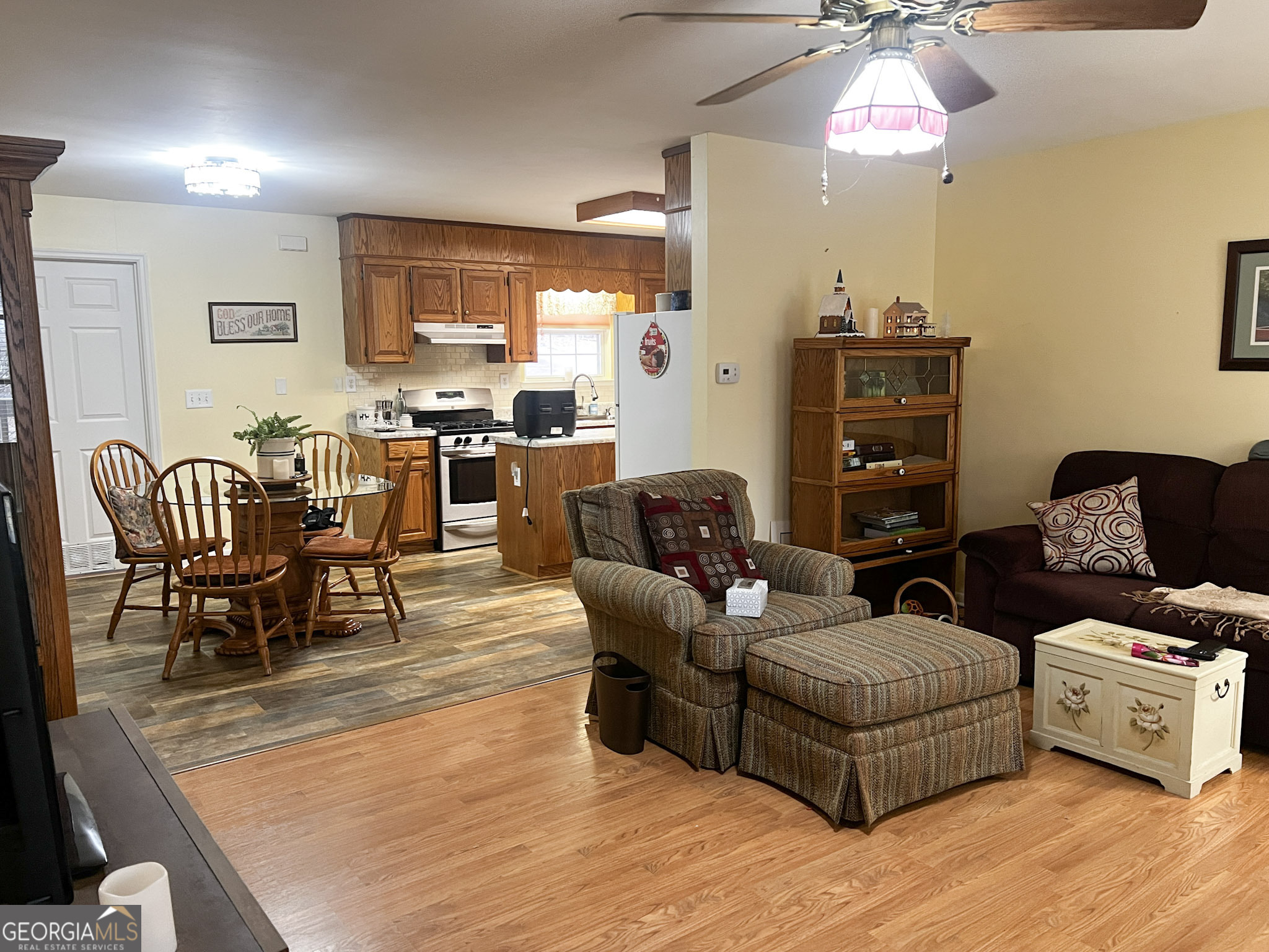 153 View Street Clarkesville, GA 30523 - Photo 8 of 31 a living room with furniture and a dining table with wooden floor