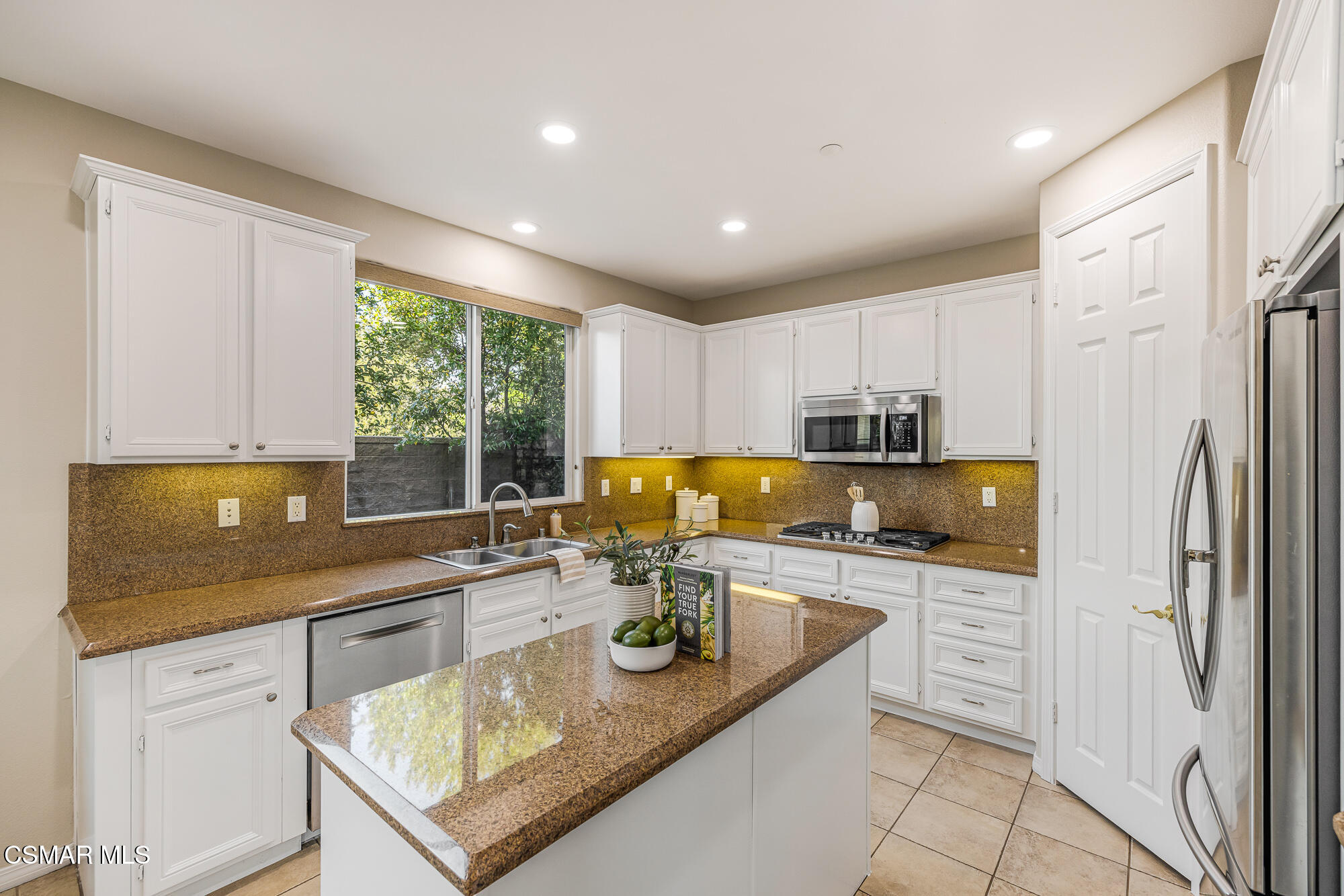 5353 Willow Oak Street Simi Valley, CA 93063 - Photo 11 of 52 a kitchen with stainless steel appliances granite countertop a sink stove and refrigerator