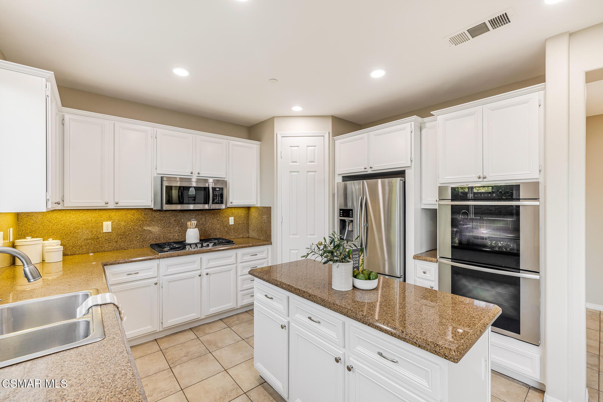 5353 Willow Oak Street Simi Valley, CA 93063 - Photo 12 of 52 a kitchen with kitchen island granite countertop a sink stove and refrigerator