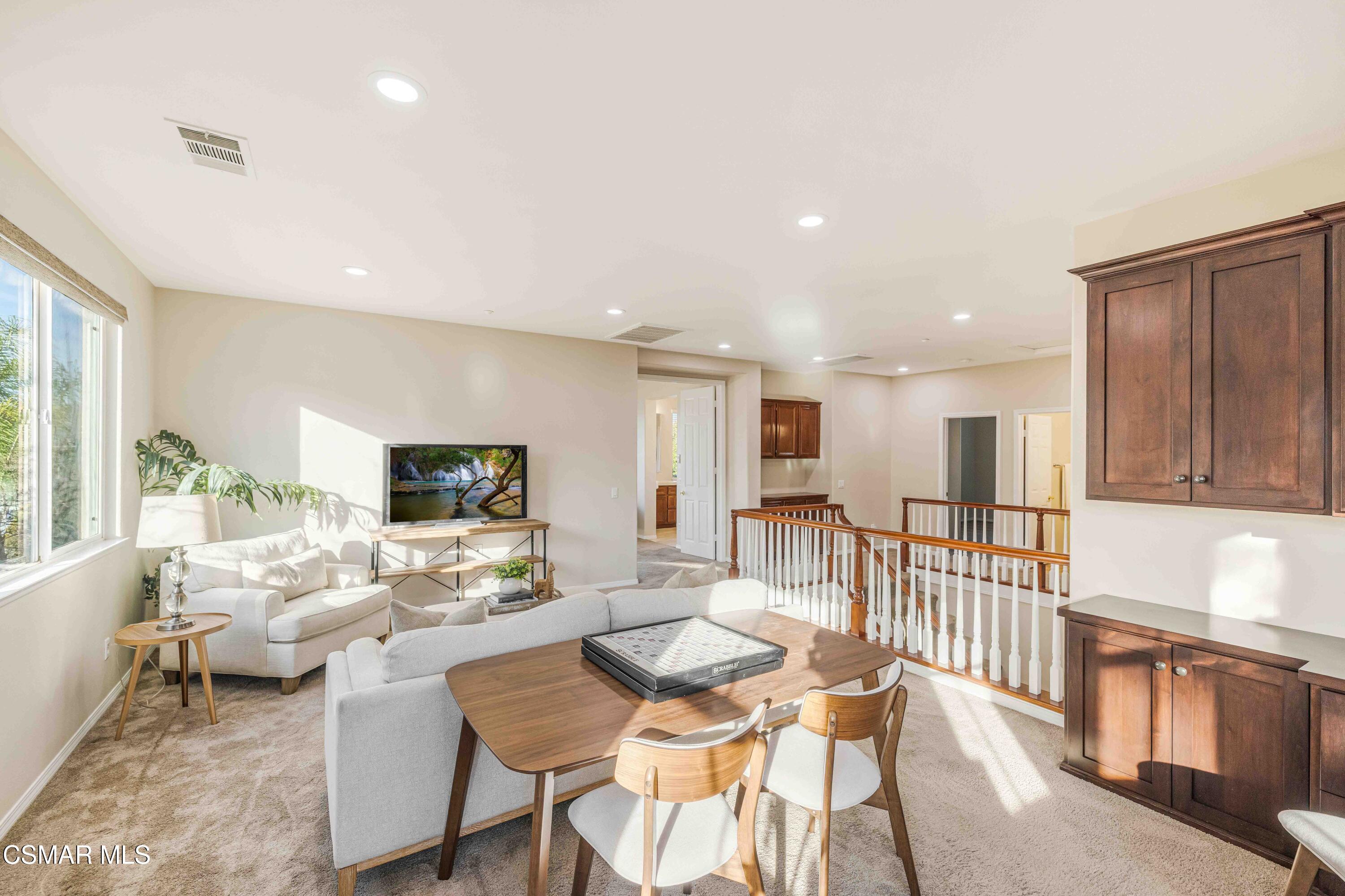 5353 Willow Oak Street Simi Valley, CA 93063 - Photo 22 of 52 a living room with furniture a flat screen tv and a large window