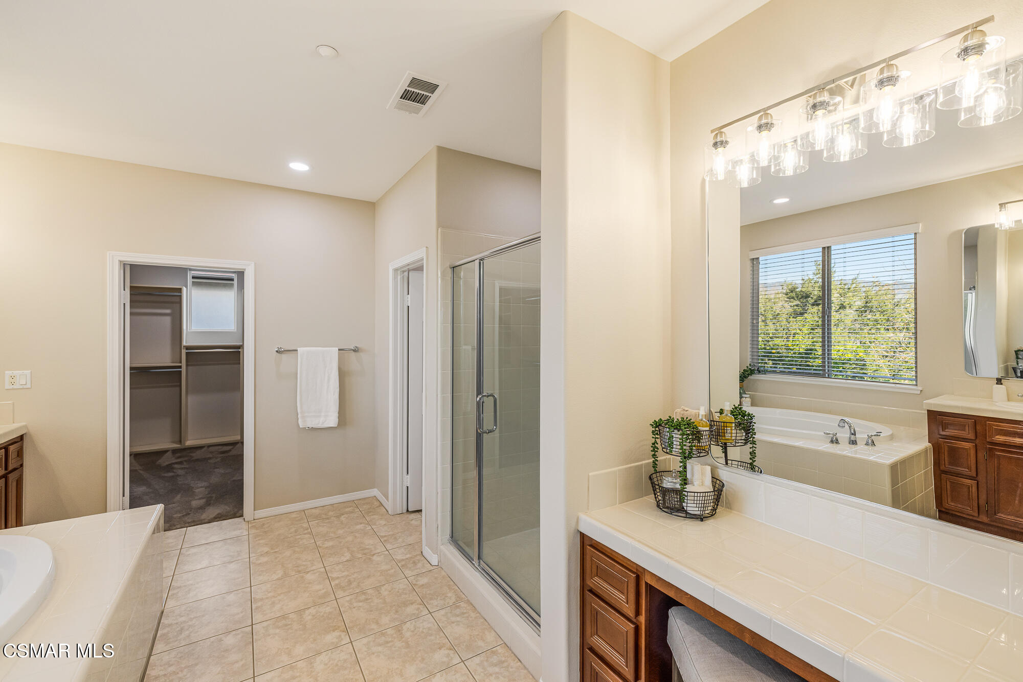 5353 Willow Oak Street Simi Valley, CA 93063 - Photo 37 of 52 a bathroom with a granite countertop sink a mirror and a shower