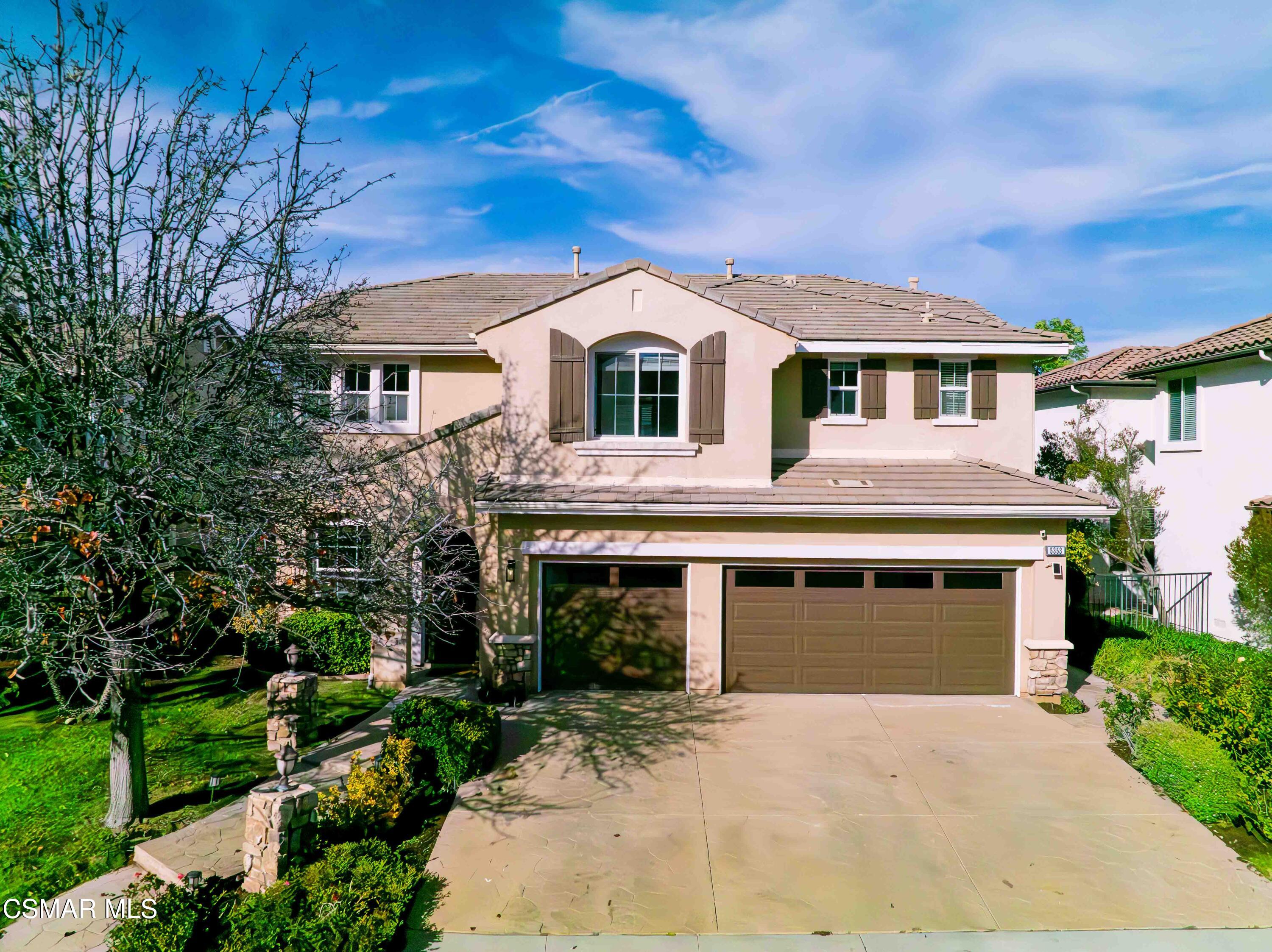 5353 Willow Oak Street Simi Valley, CA 93063 - Photo 46 of 52 a front view of a house with a garden and trees