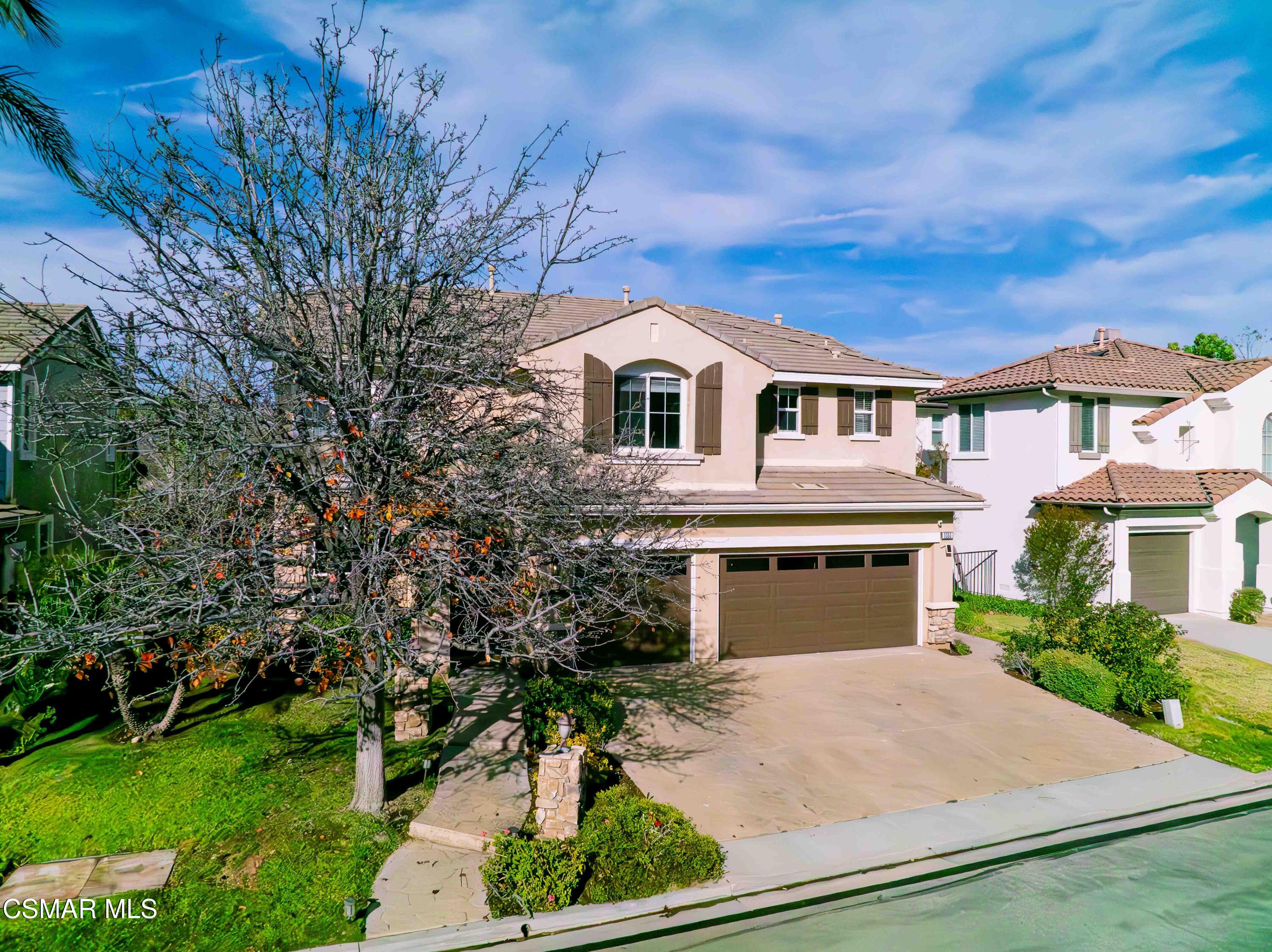 5353 Willow Oak Street Simi Valley, CA 93063 - Photo 47 of 52 a front view of a house with a yard and garage
