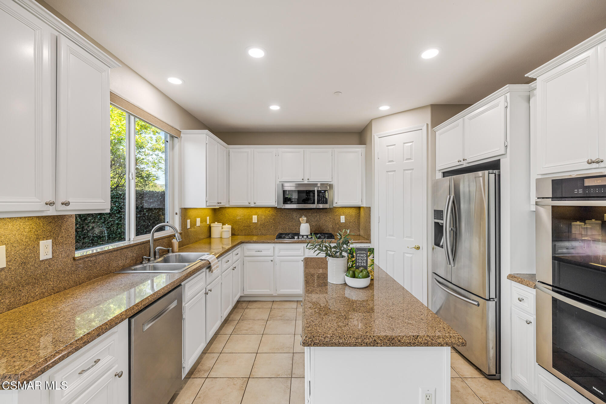 5353 Willow Oak Street Simi Valley, CA 93063 - Photo 10 of 52 a kitchen with stainless steel appliances granite countertop a sink refrigerator and cabinets
