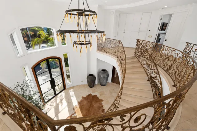 a spacious bedroom with a large bed and a large window