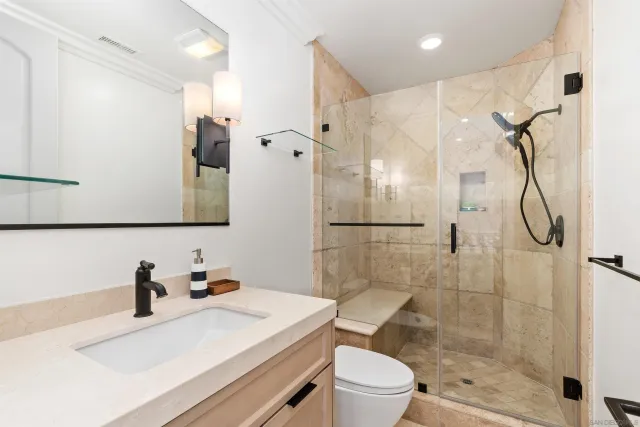 a bathroom with a sink vanity granite tub and shower