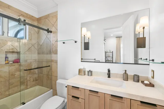 a view of a swimming pool and lounge chairs in the patio