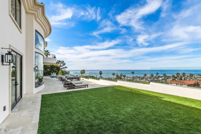a terrace with outdoor seating and city view