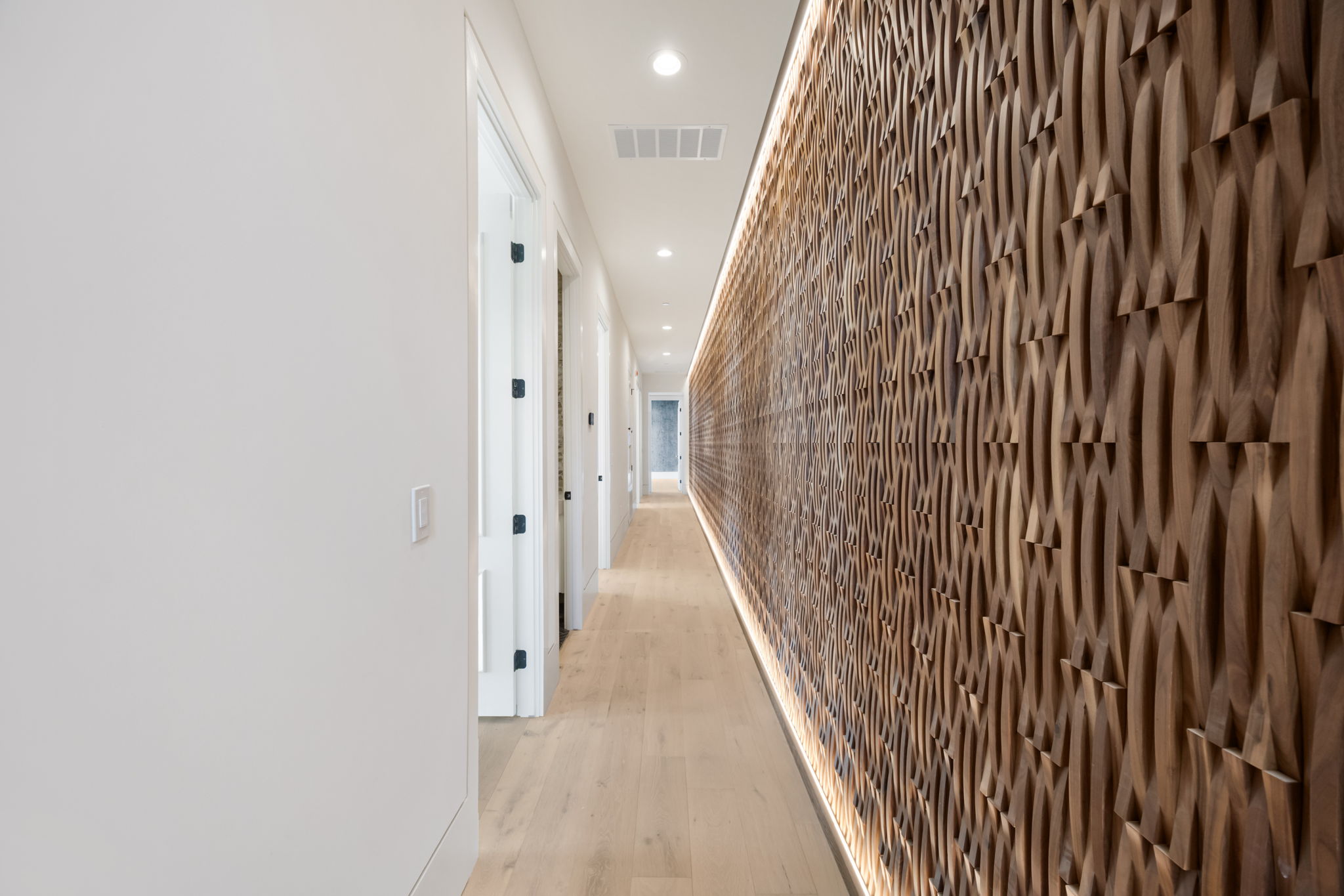 1496 Buffalo Gap Road Lakeway, TX 78734 - Photo 28 of 37 Artistic wood paneling creates a captivating visual journey along this elegant hallway.