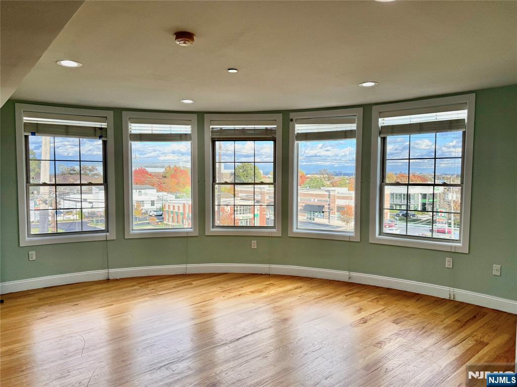 132 Union Avenue, Unit 405A East Rutherford, NJ 07073 - Photo 2 of 11 a view of empty room with wooden floor and fan