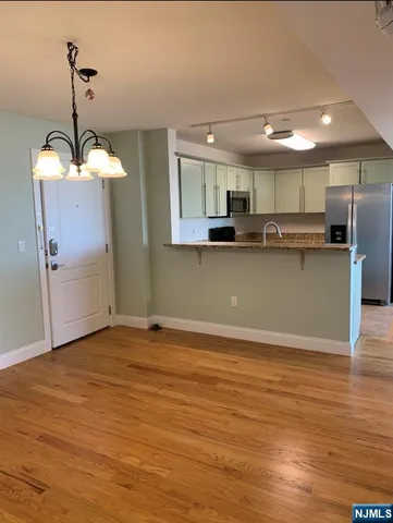 a view of kitchen with sink microwave and refrigerator