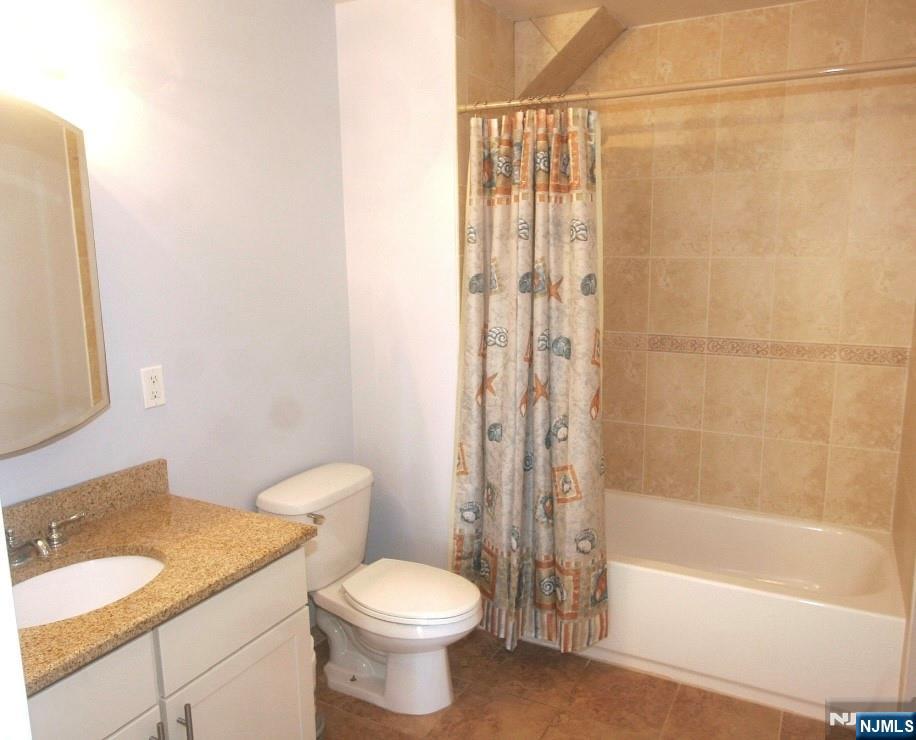132 Union Avenue, Unit 405A East Rutherford, NJ 07073 - Photo 6 of 11 a bathroom with a granite countertop sink toilet and shower