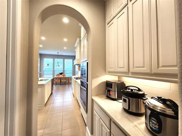 a kitchen with a sink a counter top space and stainless steel appliances