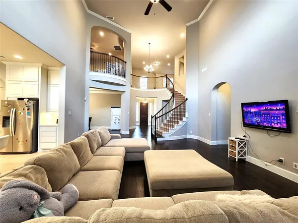 a living room with furniture and a chandelier