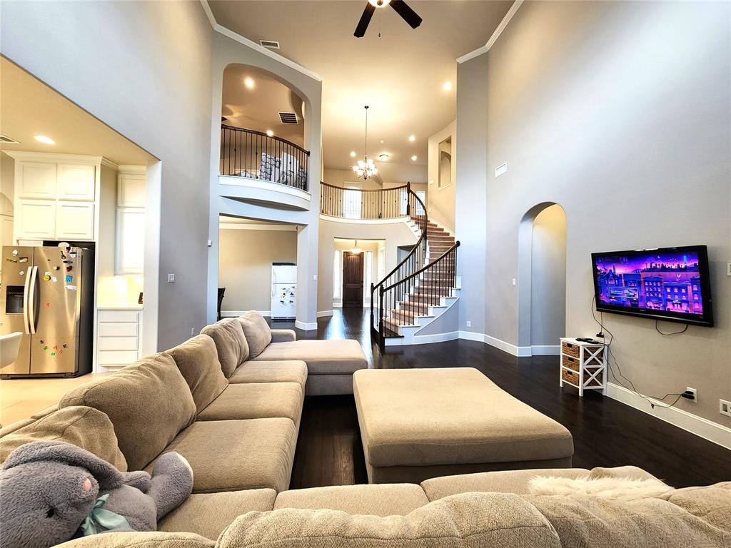 7163 Split Rein Road Frisco, TX 75036 - Photo 17 of 40 a living room with furniture and a chandelier