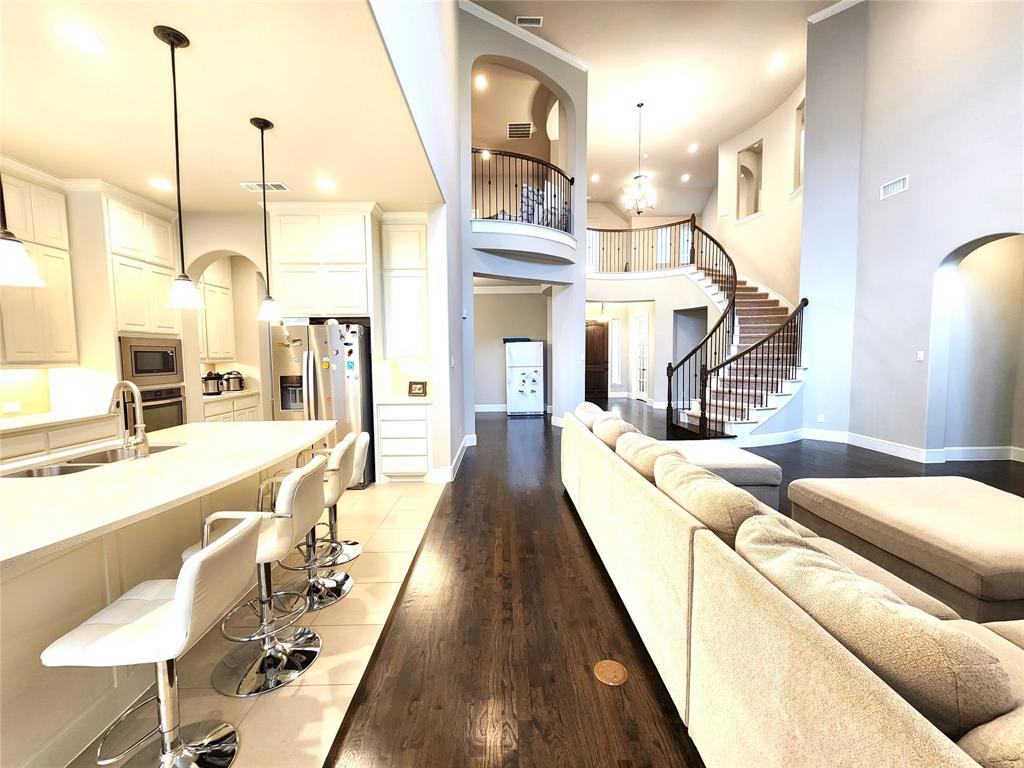 7163 Split Rein Road Frisco, TX 75036 - Photo 21 of 40 a living room with furniture a large window and wooden floor