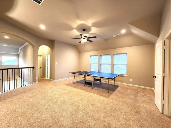 a view of a room with furniture and a ceiling fan