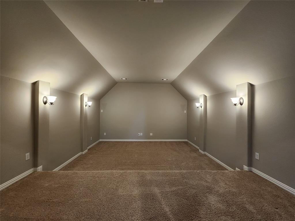 7163 Split Rein Road Frisco, TX 75036 - Photo 34 of 40 an empty room with yellow lighting